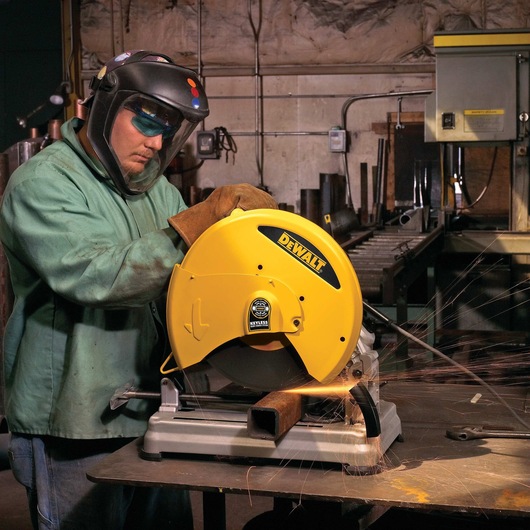 Chop Saw with QUIK-CHANGE™ Keyless Blade Change System being used by a person to cut metal rod