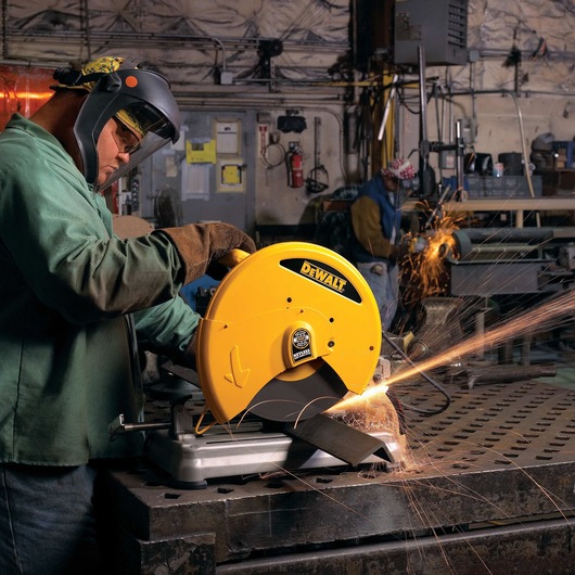 Chop Saw with QUIK-CHANGE™ Keyless Blade Change System being used by a person to cut metal