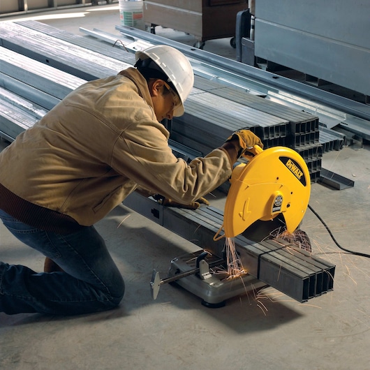 Chop Saw with QUIK-CHANGE™ Keyless Blade Change System being used to cut metal rods