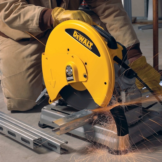 Chop Saw with QUIK-CHANGE™ Keyless Blade Change System being used to slice a meta bar