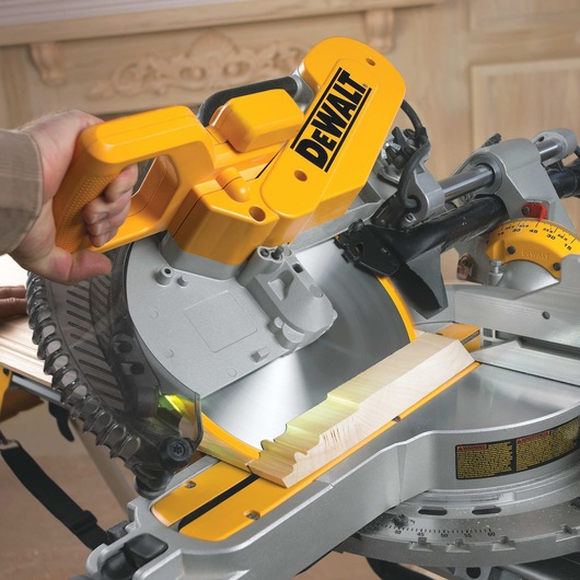 Close up of 12 inch double bevel sliding compound miter saw in action.
